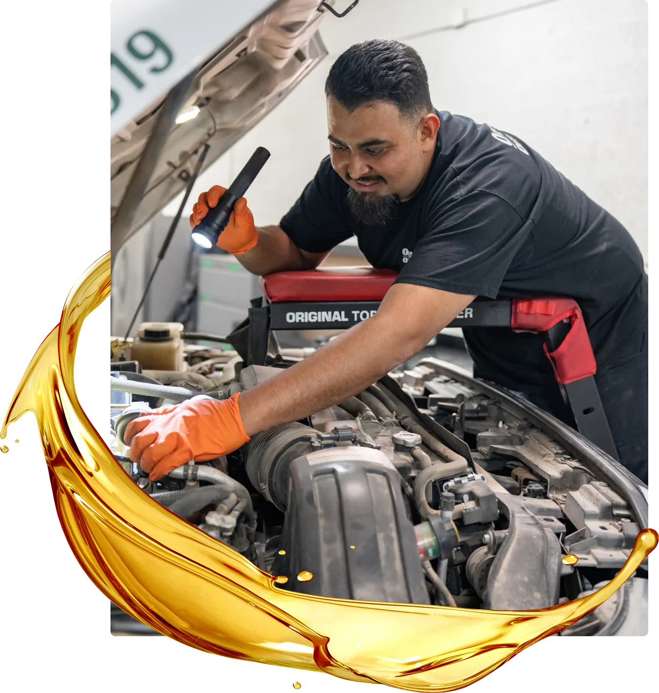 A mechanic wearing orange gloves uses a flashlight to inspect a car engine under an open hood, showcasing the convenience of mobile auto repair. A gold oil splash graphic curves across the bottom left of the image.