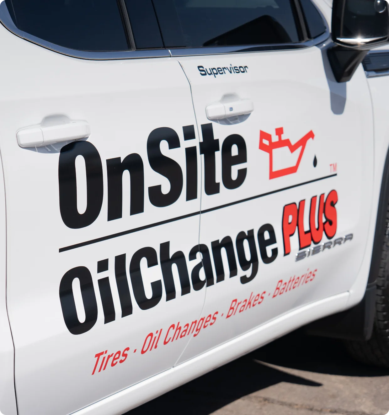 The side of a white vehicle displays OnSite OilChange PLUS with a red oil can icon and a list of services including tires, oil changes, brakes, and batteries. The word Supervisor is above the door handle.